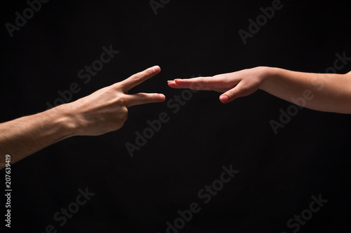 Rock Paper Scissors game isolated on black photo