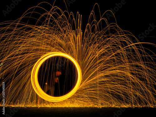 Steel wool light painting as a circle in the dark background