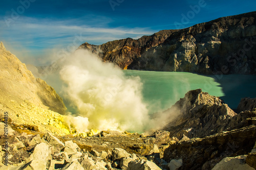 Smoking Kawah Ijen volcano crater with sulphur mine, Indonesia