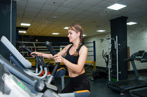 Ukraine, Chernigov, May 20, 2018: sports smiling young woman practicing at the gym. Weight loss and cardio workout.