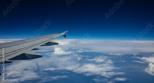 Plane wing on blue sky background