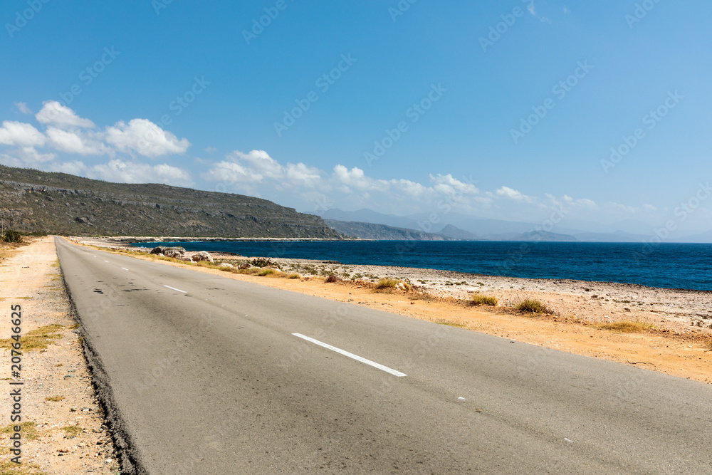 empty road to guantanamo with the ocean Cuba