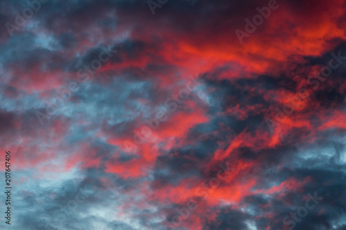 majestic red and orange clouds in sky during sunset © VarnakovR