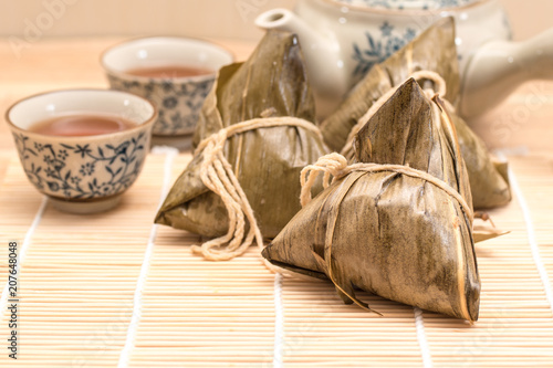 Zongzi - Traditional Dragon Boat Festival dumpling. Hand drawn watercolor painting isolated on wood background.