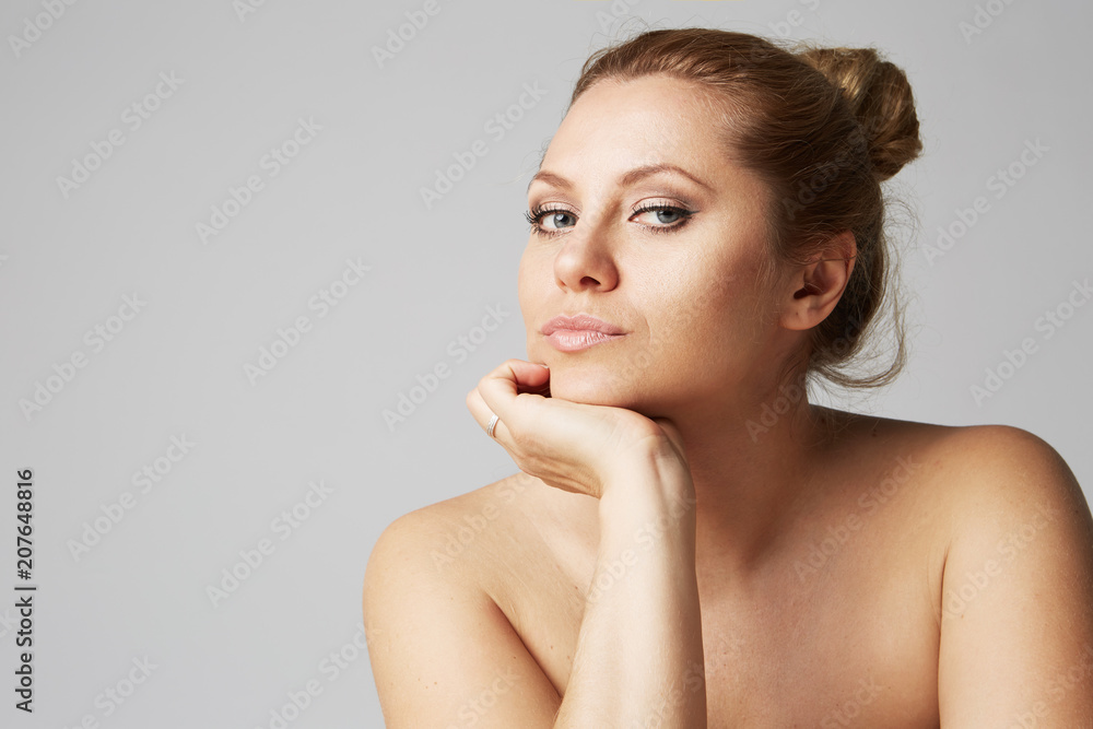 Beautiful girl with big eyes and dark eyebrows, with naked shoulders,  looking at camera.Model with light nude make-up, gray studio background,  beauty photo, copy space, close up Stock Photo | Adobe Stock