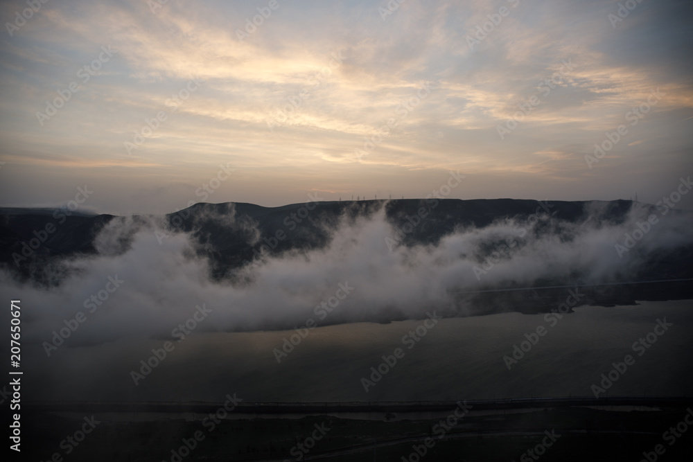 Beautiful clouds flying over the lake near mountains. Evening time shot over the clouds. Baku, Azerbaijan