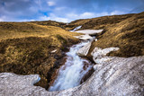 Icelandic wilderness - May 08, 2018: Small waterfall in the icy wilderness of Iceland