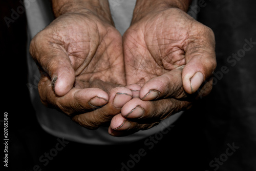Hands poor poverty elder man begging you for help. Concept hunger people or poverty. Selective focus. Poverty in retirement. photo