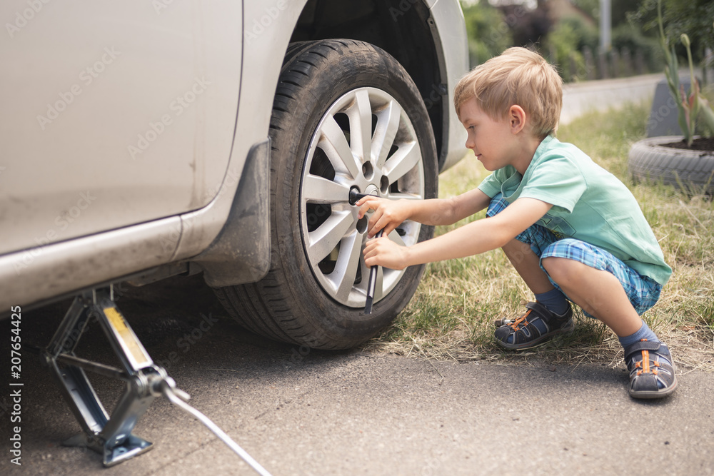 Little changes the punctured wheel on the side of the road Little changes the punctured wheel on the side of the road