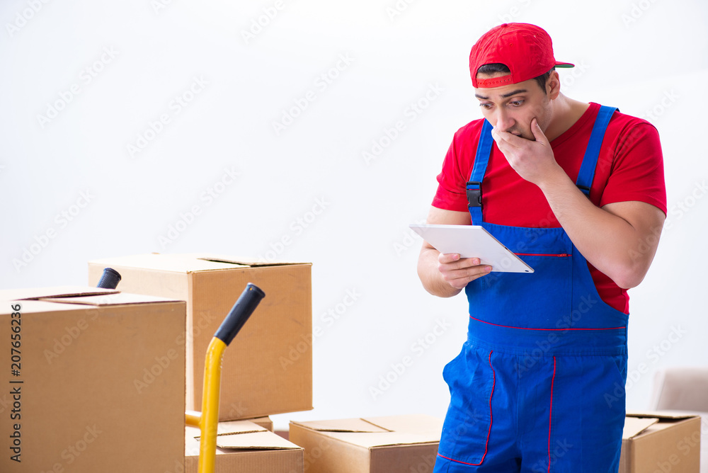 Contractor worker moving boxes during office move Contractor worker moving boxes during office move