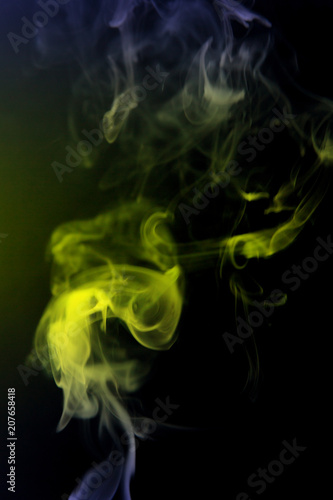 Texture of yellow smoke on a black background.