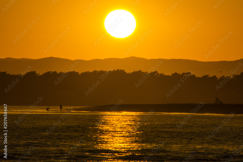 The sun goes down over the spanish border with Portugal at Isla Canela, Huelva
