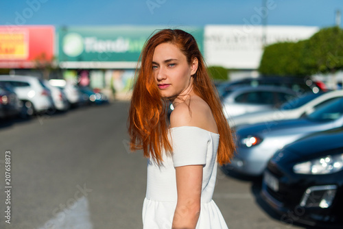 Portrait of young redhead pretty girl in outdoor