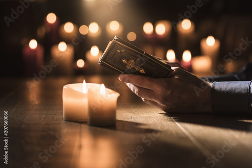 Man reading the Holy Bible and praying in the Church photo