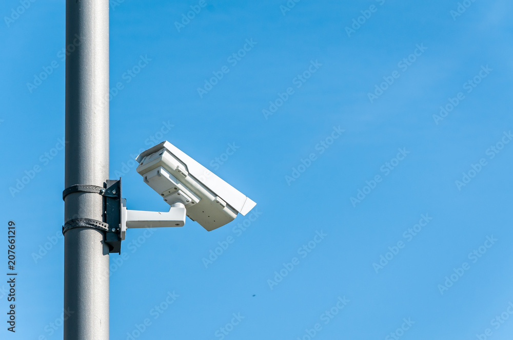 City cctv security surveillance camera system attached on the traffic light pole with clear blue sky background City cctv security surveillance camera system attached on the traffic light pole with clear blue sky background