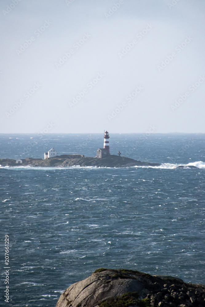 Lighthouse in winter storm Atlantic ocean