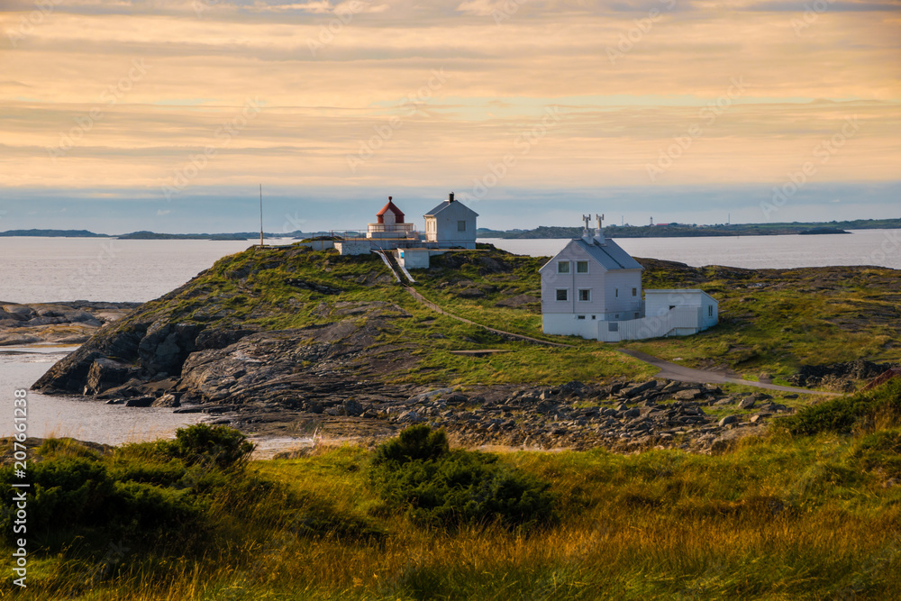 Lighthouse at coast Norway sunset