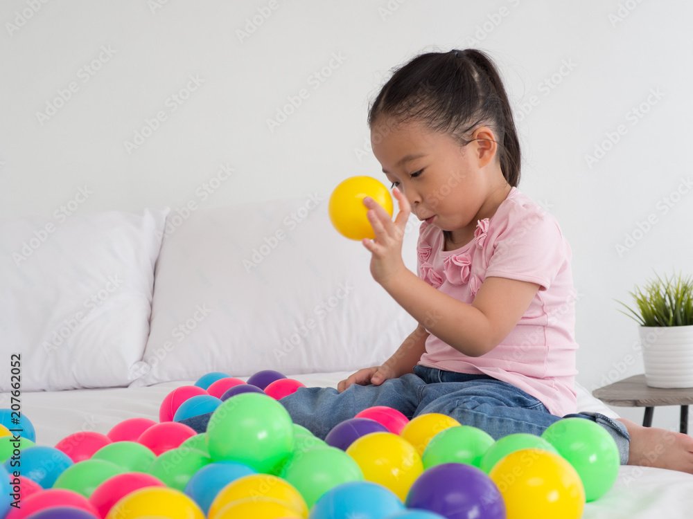 young Asian Kid playing colorful ball. young Asian Kid playing colorful ball.