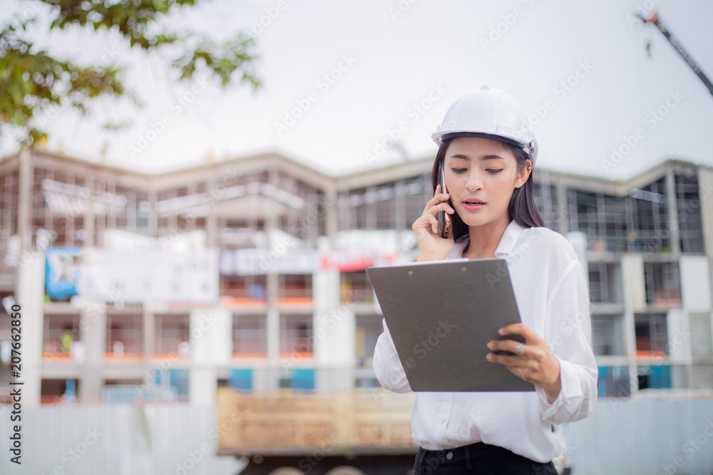 Female engineer inspecting construction work in hand holding clipboard with document. Female engineer inspecting construction work in hand holding clipboard with document.