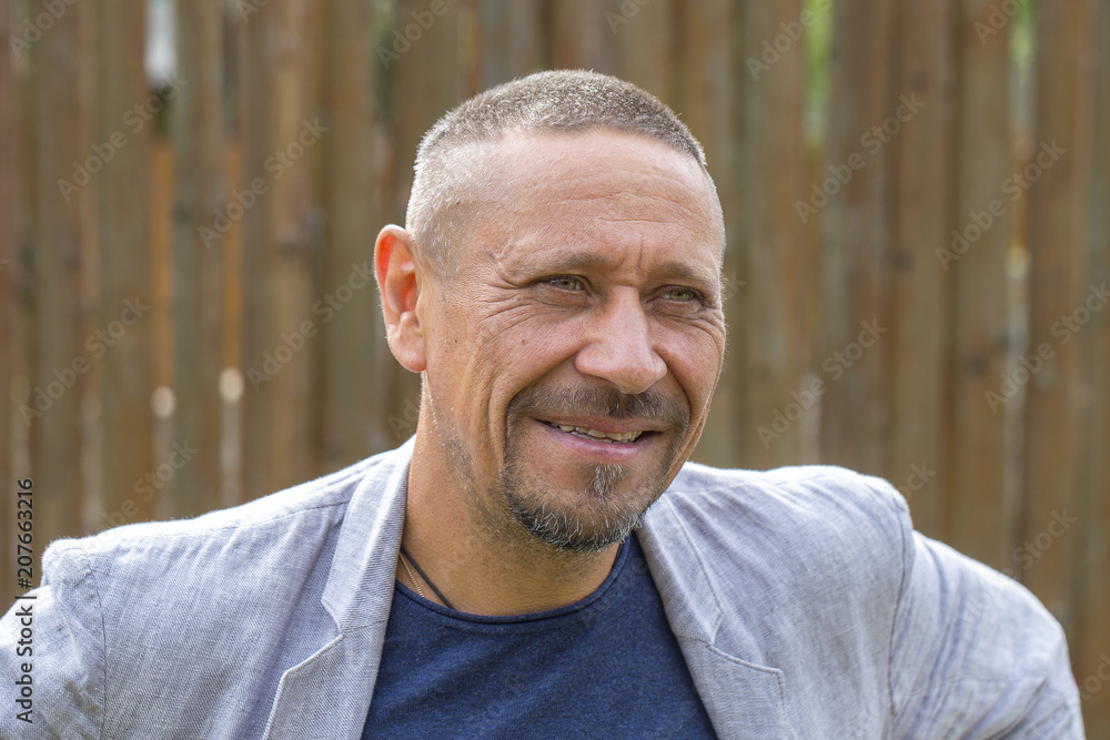 People and lifestyle concept. Happy middle-aged unshaven man outdoors, portrait close up People and lifestyle concept. Happy middle-aged unshaven man outdoors, portrait close up