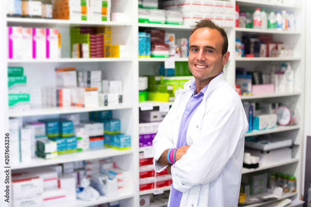 Happy adult man pharmacist in pharmacy