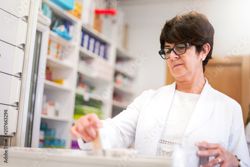 Middle-aged woman customer in the pharmacy looking for medications