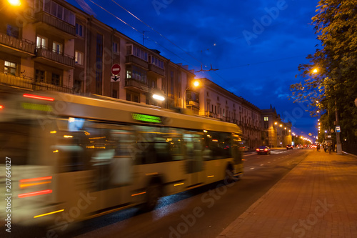 The motion of a blurred trolleybus in the street in the evening. © leon134865