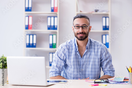 Young designer working in his studio on new project