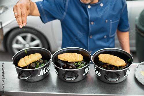 Preparation of mussels. Mussels in a frying pan. Street food.