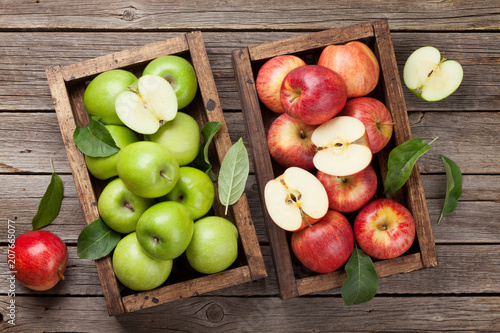 Green and red apples in wooden box