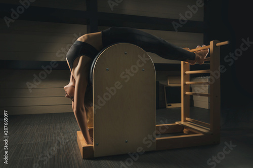 a woman is engaged in Pilates. fitness and sports photo