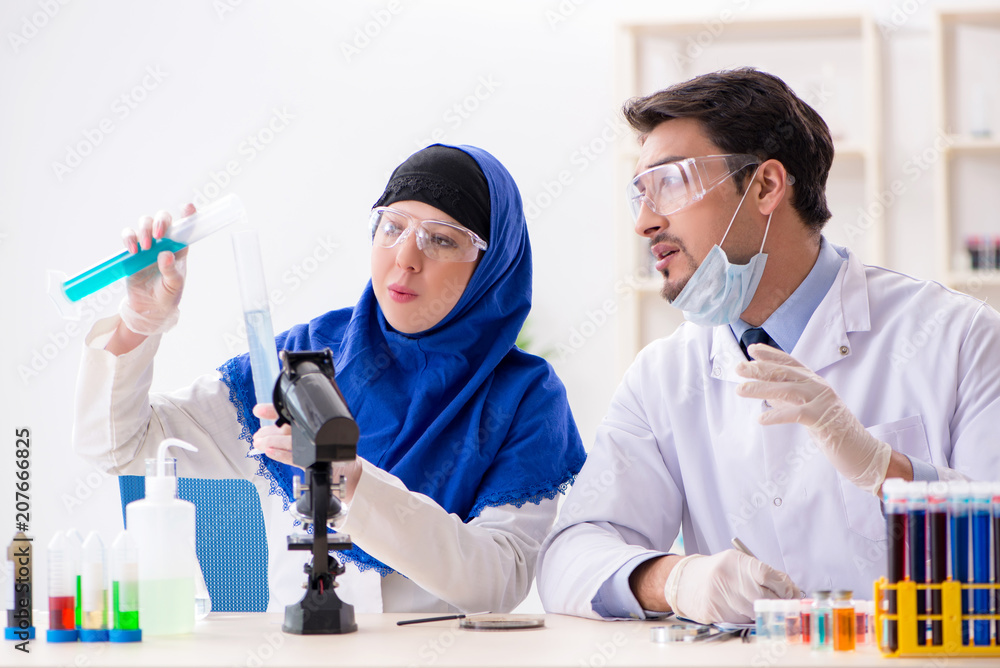 Two chemists working in the lab Two chemists working in the lab