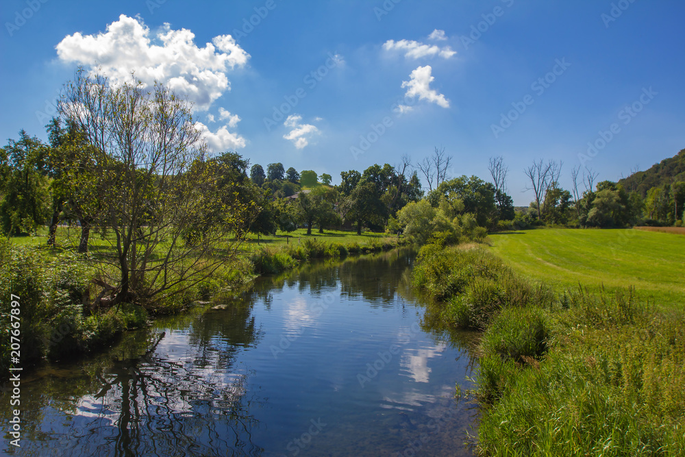 A beautiful summer landscape / A small river among meadows and fields