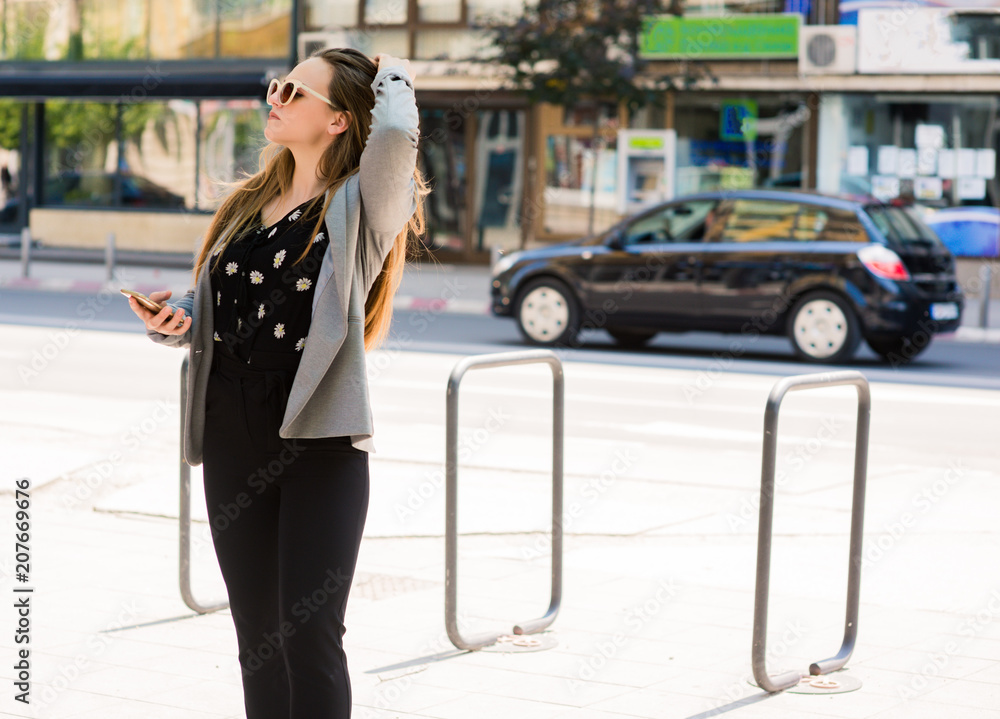 Business girl standing on the path in the city Business girl standing on the path in the city