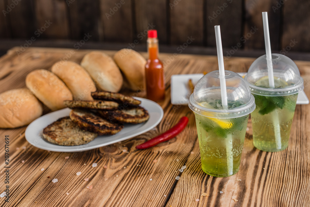 Tasty hamburger with meat and vegetables against a dark background. Fast food. It can be used as a background Tasty hamburger with meat and vegetables against a dark background. Fast food. It can be used as a background