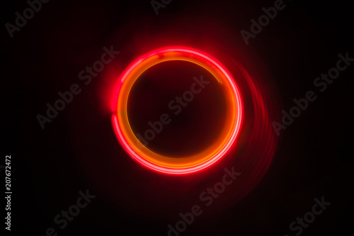 Music concept. Freezelight glowing vinyl on dark background or Turntable playing vinyl with glowing abstract lines concept on dark background.