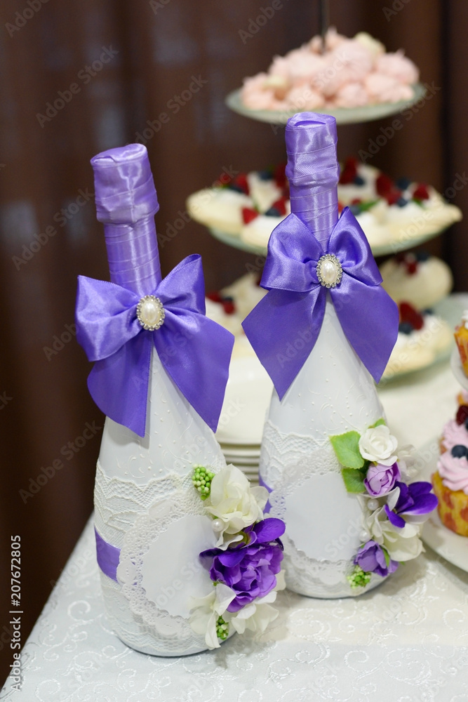wedding decoration elements, two bottles of champagne decorated with blue silk ribbons bows and flowers wedding decoration elements, two bottles of champagne decorated with blue silk ribbons bows and flowers