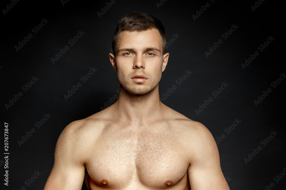 Fototapeta premium Sport guy portrait on black background