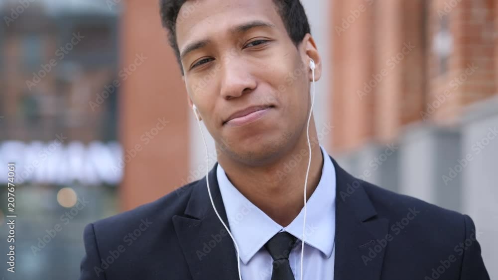 Online Video Chat by African Businessman Sitting on Stairs Online Video Chat by African Businessman Sitting on Stairs