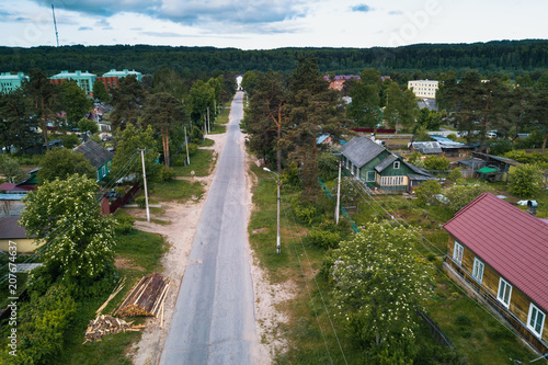 Russian urban-type settlement with wooden houses in green forests of Leningrad region, Russia.