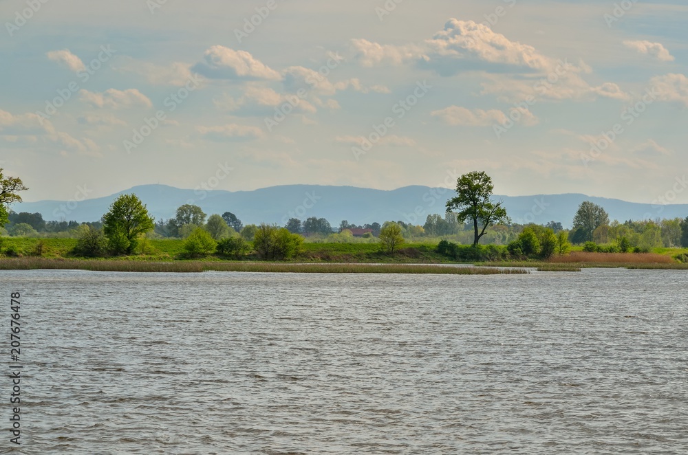 Beautiful rural landscape. Spring day over a beautiful pond. Beautiful rural landscape. Spring day over a beautiful pond.