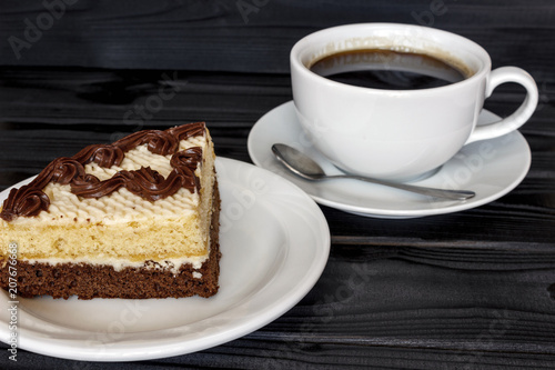 a piece of cake in a plate with a cup of coffee