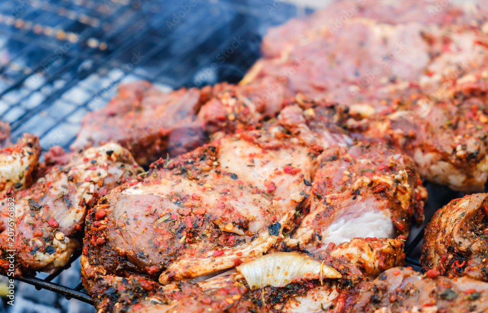 BBQ Roasted Pork Meat With herb spice On The Hot Charcoal Grill With Smoke.