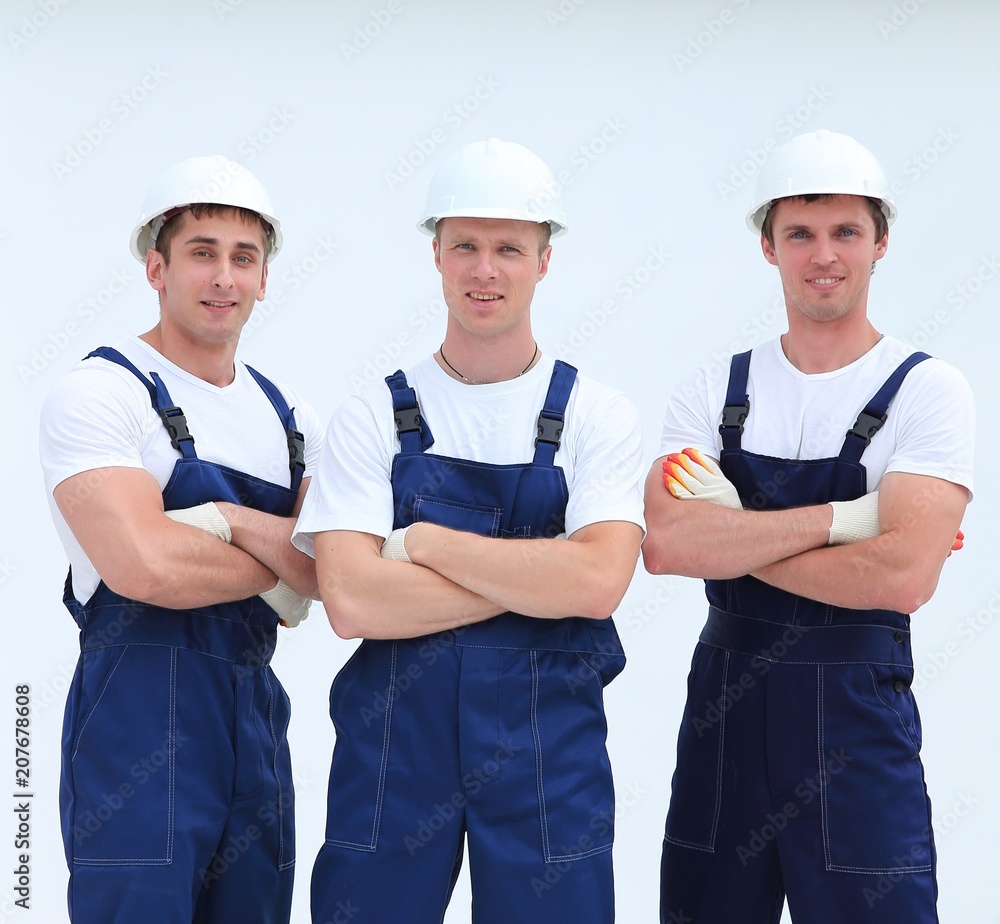 successful team builders in overalls and helmets successful team builders in overalls and helmets