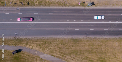 June 03, 2018. Riga, Latvia. View on the classical American retro car parade in Riga, Latvia by the huge MSC cruise Orchestra. Vintage convertible cars driving down the empty street. photo