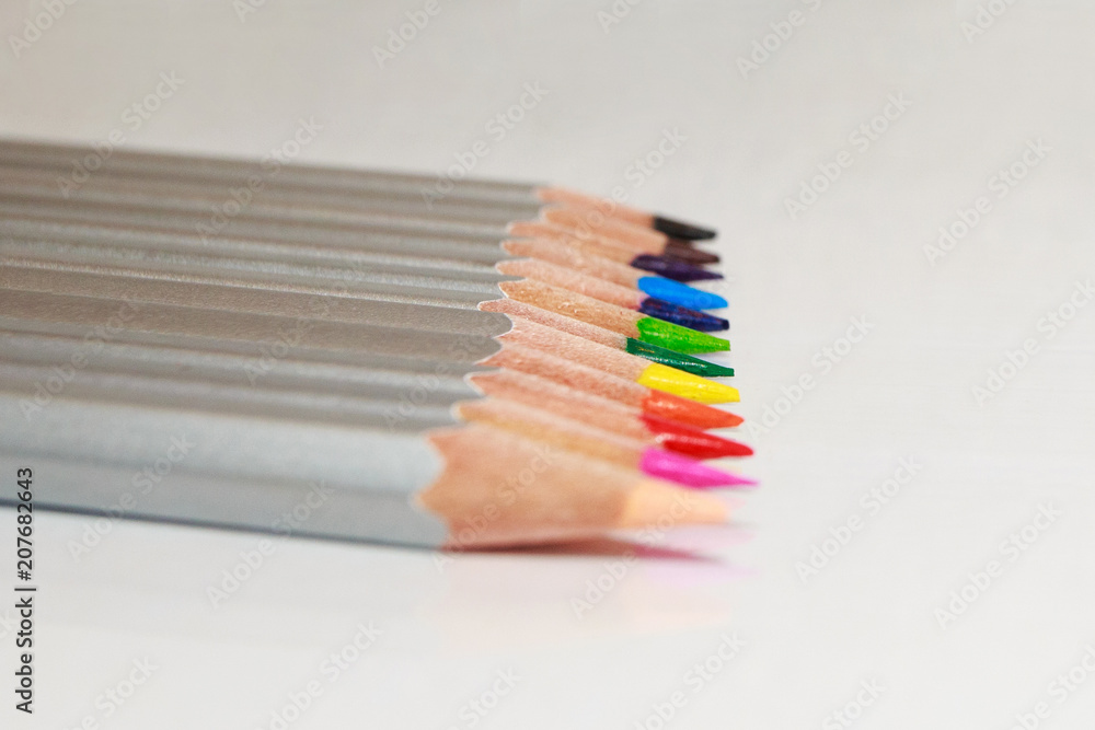 Obraz premium Color pencils lie in a line on white background.
