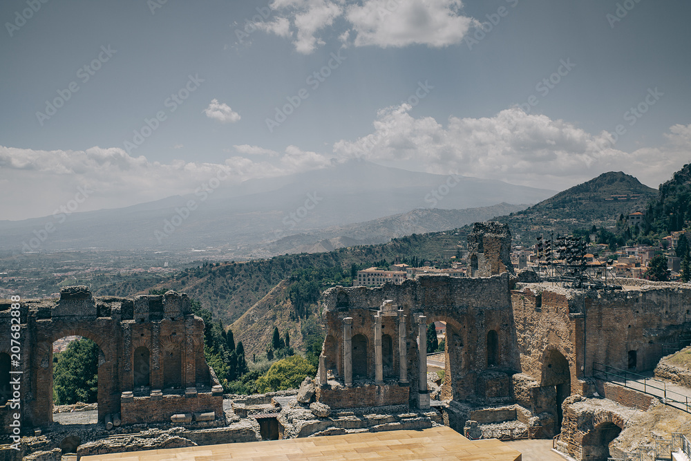 Taormina greek theater with etna volcano as background