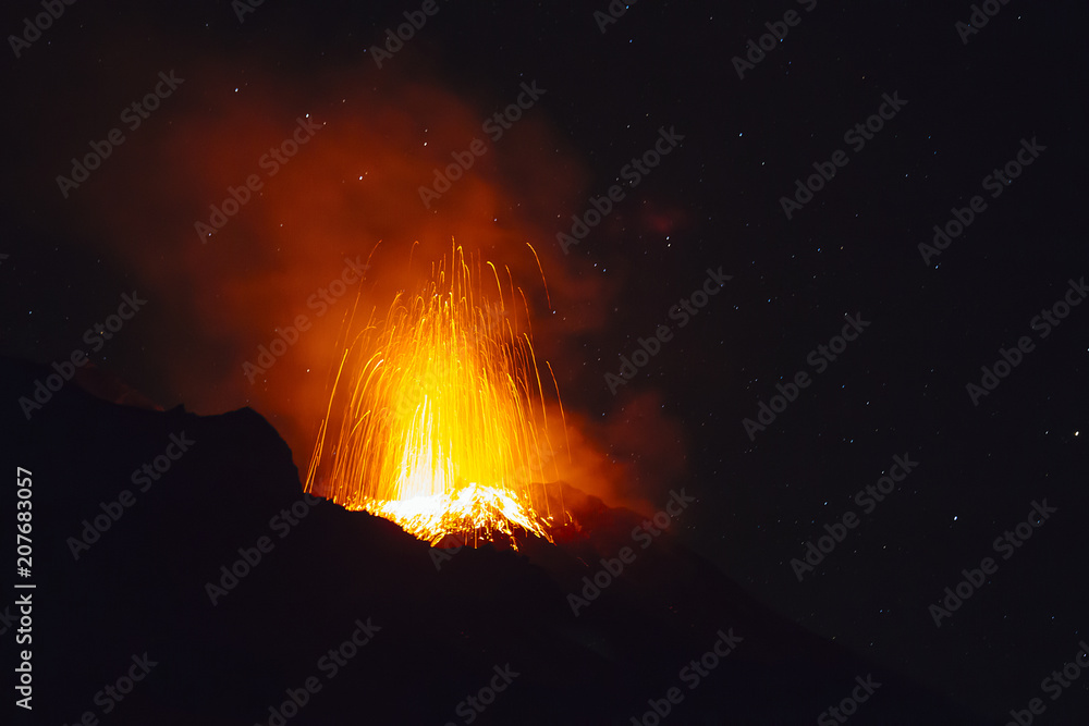Stromboli volcano eruption during a starry night