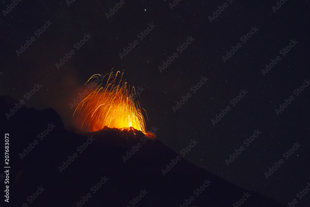 Stromboli volcano eruption during a starry night Stock Photo | Adobe Stock