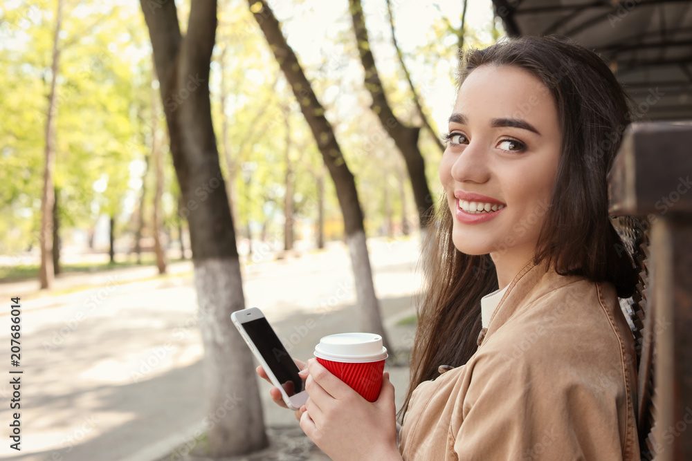 Young woman using phone outdoors on sunny day Young woman using phone outdoors on sunny day
